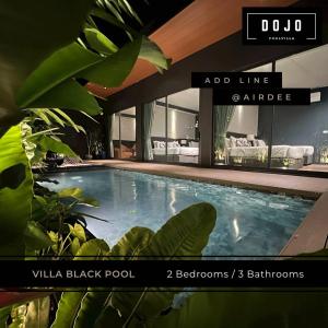 a large swimming pool in a building with plants at Dojo pool villa in Jomtien Beach