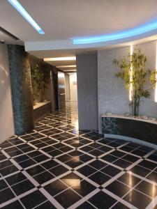 a lobby with a black and white tiled floor at La torre in Latina