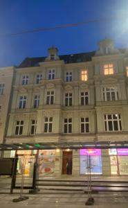 a large building on a street at night at CRYSTAL Św. Marcin Poznań in Poznań