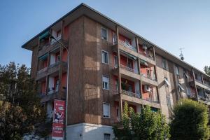 a brick building with balconies on the side of it at [Linate Airport] Elegant Suite,Tram 1 minute away in Milan