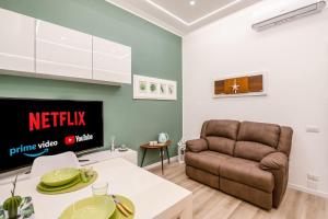 a living room with a couch and a table at [Linate Airport] Elegant Suite,Tram 1 minute away in Milan