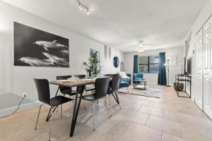 a dining room and living room with a table and chairs at Cheerful Townhouse w/ 2 Ensuite Bedrooms and Yard in Ponte Vedra Beach