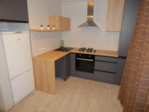 a small kitchen with a sink and a stove at Confortable apartment in Chişinău