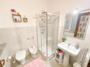 a bathroom with a toilet a sink and a shower at Al Politeama Rooms B&B in Palermo