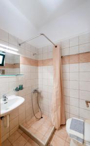 a bathroom with a shower and a sink at Nikolas Studios in Agios Nikitas