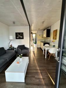 a living room with a couch and a table at Ferienwohnung SEE UND MEHR in Stetten