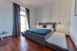 a bedroom with a bed with a blue blanket at Luxury Seaview Apartment in Opatija