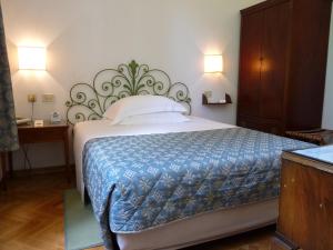 A bed or beds in a room at Classic Hotel