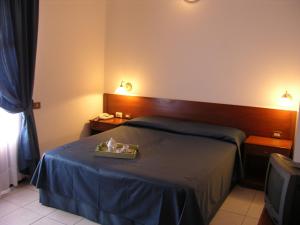 a hotel room with a bed with a tray on it at Hotel Su Giudeu in Chia