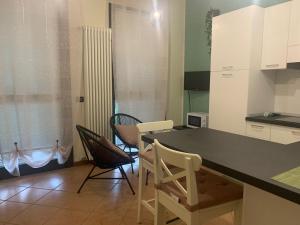 a kitchen with a table and chairs in a room at 3T House 2 in Cremona