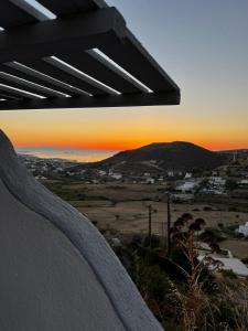 a view of a sunset from a bench at Paros Villas Nereids in Parikia