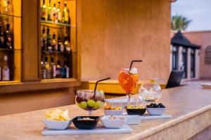 a bar with appetizers and drinks on a counter at Berbère Palace in Ouarzazate