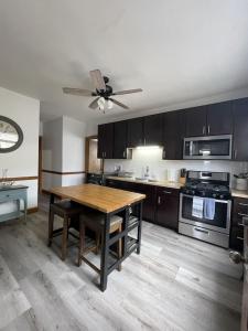 a kitchen with a wooden table and a ceiling fan at The Karlov. Gorgeous ,spacious 2BD/ 1BA w/ Parking in Chicago