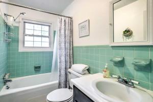a bathroom with a sink and a toilet and a tub at Lovely Taylors Home 8 Mi to Dtwn Greenville! in Greer