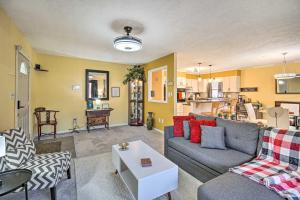 a living room with a couch and a table at Sauna and Game Room Lake House in Locust Grove! in Wilderness