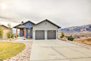 a house with a garage with mountains in the background at Eden Home with Stunning View about 6 Mi to Skiing! in Eden