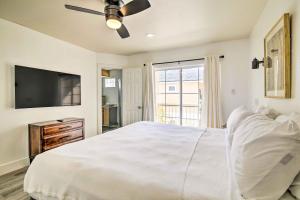 a bedroom with a bed and a flat screen tv at South Padre Island Getaway - Newly Renovated! in South Padre Island +17 photos