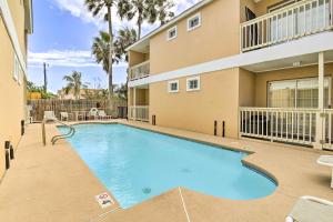 a swimming pool in front of a building at South Padre Island Getaway - Newly Renovated! in South Padre Island