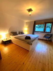 a bedroom with a large bed and a window at Ferienwohnung mit Sauna am Wald - Eifel in Kommern