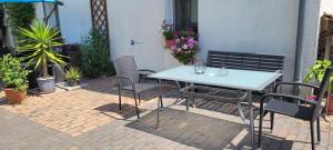 una mesa y sillas en un patio de ladrillo con plantas en Vor den Toren Dresdens und der Oberlausitz, en Radeberg