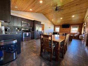 a kitchen and dining room with a wooden ceiling at North Haven Campground in Bonners Ferry