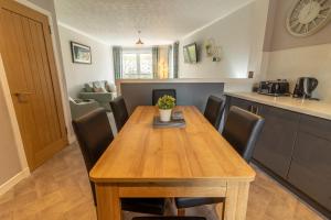 a kitchen and dining room with a wooden table and chairs at Fishertown House in Nairn