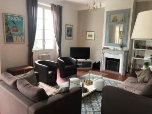 a living room with a couch and chairs and a fireplace at TOULON - Côte d'Azur - Magnifique maison avec piscine privée in Toulon