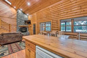 a log cabin with a dining room and a fireplace at Mtn Retreat in Angel Fire - Ride 4 Blocks to Lift! in Angel Fire