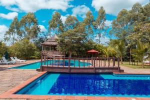 a swimming pool with a gazebo next to a resort at Murchison Backpackers in Masindi