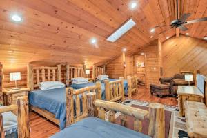 a log cabin bedroom with two beds and a couch at Mtn Retreat in Angel Fire - Ride 4 Blocks to Lift! in Angel Fire