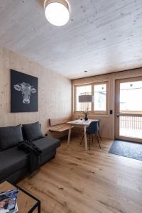a living room with a couch and a table at Boutique Apartments Mellau in Mellau