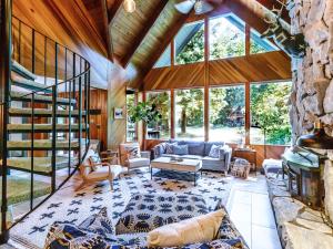 an open living room with a large glass wall at Pendleton Pines Lodge in Glacier