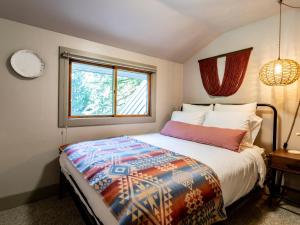 a bedroom with a bed and a window at Pendleton Pines Lodge in Glacier
