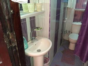 a small bathroom with a sink and a toilet at Ra Guest house in Cairo