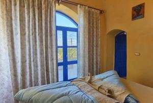 a bed in a room with a large window at Lemon tree villa in Tunis