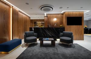 a lobby with two chairs and a table and a television at Gleam Collection Hotel in Istanbul