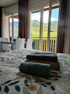 a bedroom with a bed with two towels on it at AC Apartaments Suite in Pas de la Casa