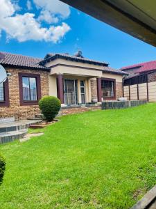 a house with a lawn in front of it at Bloom Guest House in Pretoria +23 photos