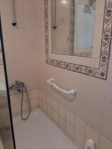 a bathroom with a shower and a mirror at Apartamentos Cavaco in Odeceixe +63 photos