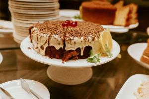 a chocolate cake on a plate on a table at Vitoria Praia Hotel in Vitória