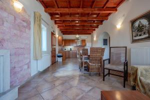 a kitchen and living room with a table and chairs at Teachers Cottage in Agia Triada