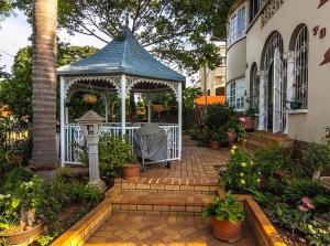 a gazebo in the middle of a garden at Rehoboth Guesthouse in Durban