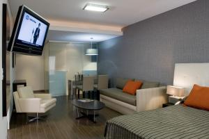 a hotel room with a bed and a tv at Recoleta Plaza by Ayres in Buenos Aires