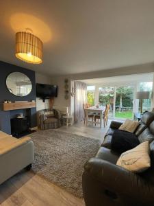 a living room with a couch and a table at Holiday home, Tywyn, newly refurbished, great location in Tywyn