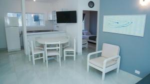 a kitchen and dining room with a table and chairs at MAKARY BEACH HOTEL in Tolú