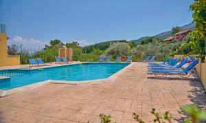 una piscina con tumbonas y un montón de plantas en Nikos Kalamaki Corfu en Apraos