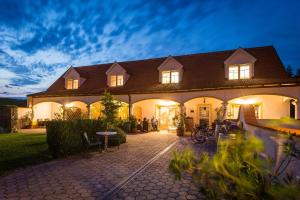 a large house with people standing outside of it at Appartementhaus Martina in Mörbisch am See