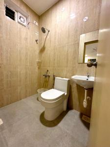 a bathroom with a toilet and a sink at Hotel Ramakrishna in Mahabalipuram