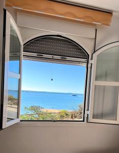 a window in a room with a view of the ocean at Estudios Costavigía Mazagón by Ramona in Mazagón