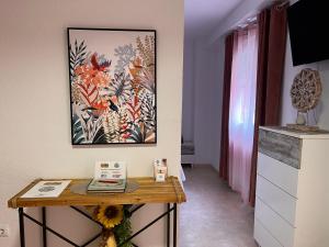 a room with a table and a painting on the wall at Estudios Costavigía Mazagón by Ramona in Mazagón
